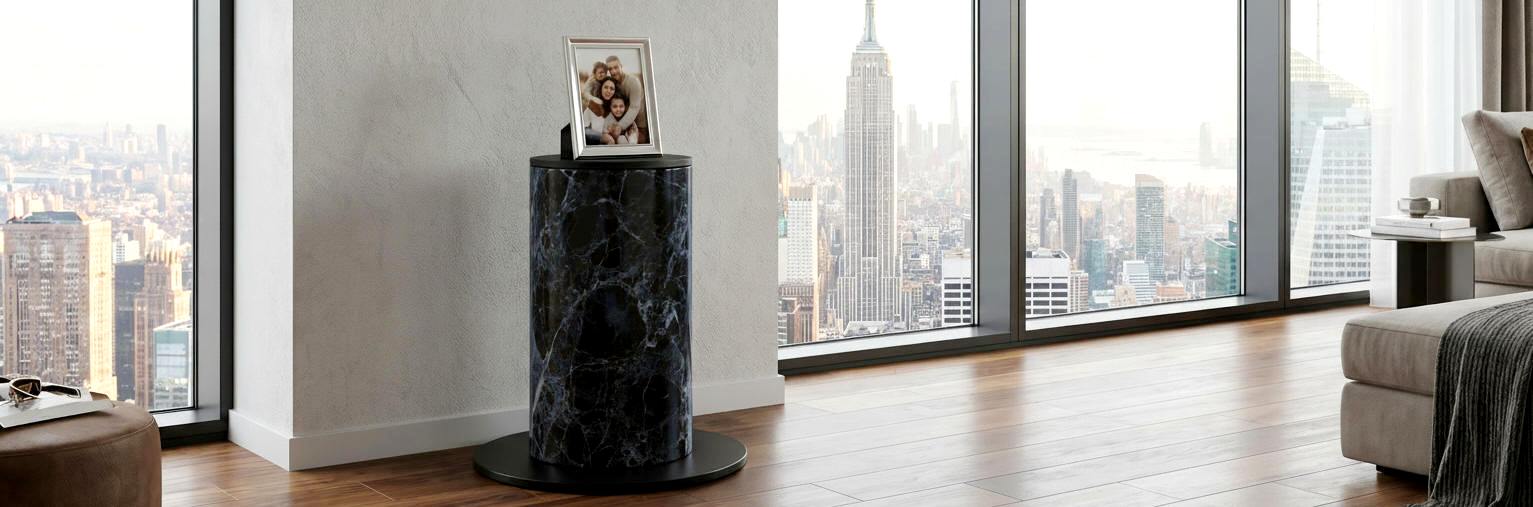 Black marble pedestal with photo frame in modern apartment living room